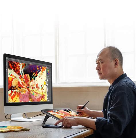 Artist using the built-in foldable stand of the XP-Pen Artist Pro 14 (Gen 2)