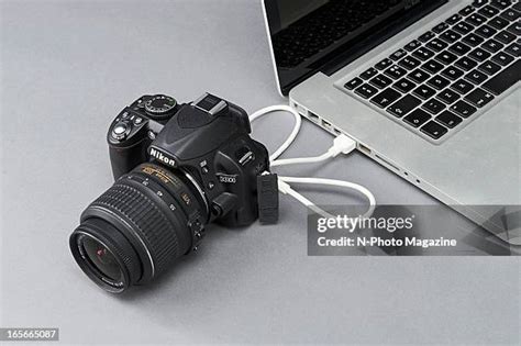 Nikon D5200 camera connected to a laptop via USB cable