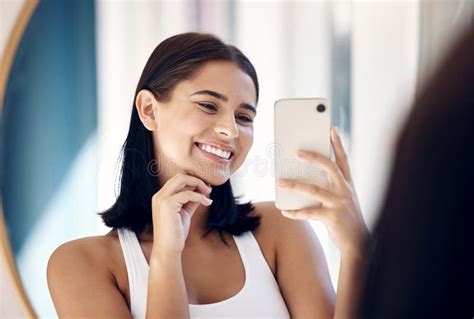 A person taking a mirror selfie with a phone
