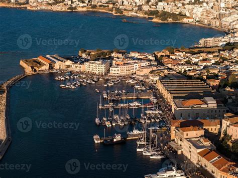Sunset view over the harbor of Chania, Crete, with traditional buildings and boats