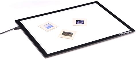 Image of a light pad with photo slides placed on it.