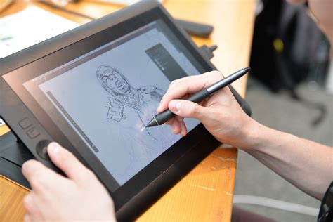 Digital artist resizing a drawing on a tablet