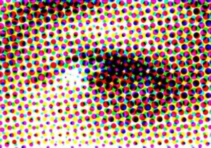 Close-up of CMYK ink dots on paper