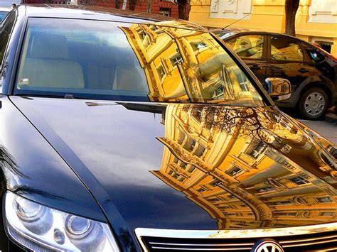 A car with a prominent reflection of the photographer on its door