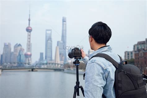Photographer using a tripod to capture multiple shots for a panorama