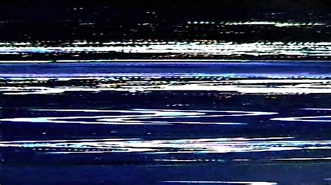 The same landscape photograph, now with visible VHS artifacts like color bleed, grain, and slight distortion