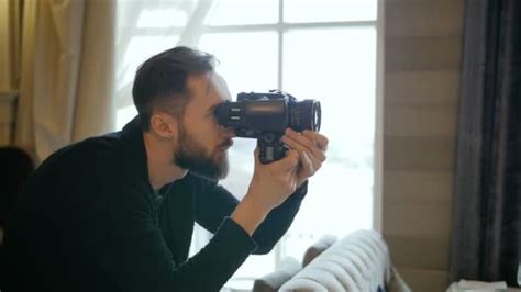 Photographer composing a portrait shot with a camera