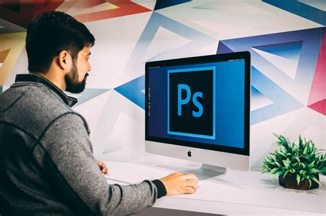 person using a computer with Photoshop software open