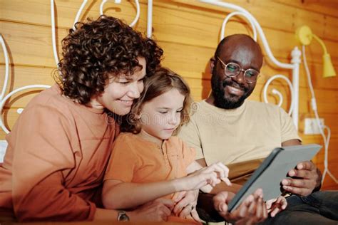 Family members looking at digitized photos on a tablet