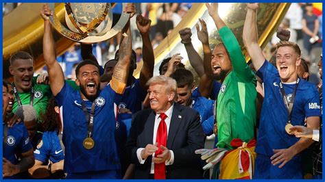 Reece James lifting a replica trophy with Donald Trump and Chelsea players in the background