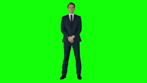 A person standing in front of a green screen.
