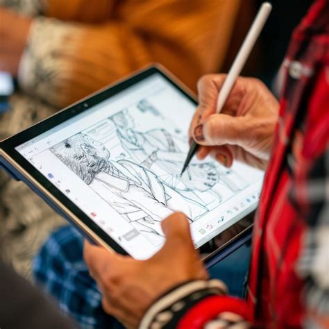 Digital artist using a stylus on a Windows tablet