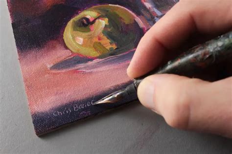 Artist signing a painting