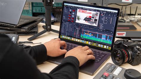 A person editing a video on a laptop with the Filmora interface visible