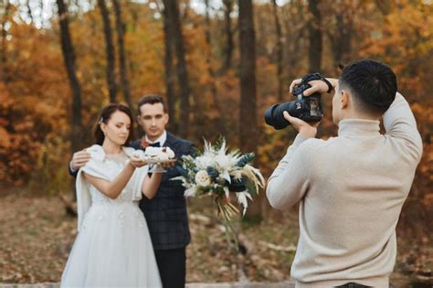 A wedding photographer interacting with a happy couple