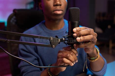 person recording audio with microphone in a slightly noisy room