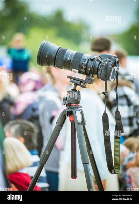 Photographer using a DSLR camera with a telephoto lens