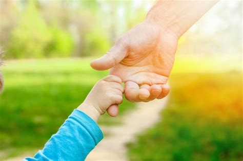 Parent holding a child's hand