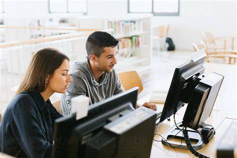 An image of a university computer lab with students using computers.