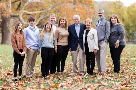 Family posing for a portrait in a park.